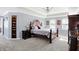 Luxurious bedroom with tray ceiling, plush carpet, and abundant natural light, creating a serene retreat at 9970 Southwind Dr, Indianapolis, IN 46256