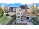 Rear exterior of home shows a deck, a brick patio, and a well manicured lawn at 9970 Southwind Dr, Indianapolis, IN 46256