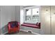 Cozy window seat with a view of the lake and an inviting armchair with soft blanket at 9970 Southwind Dr, Indianapolis, IN 46256