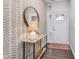 Inviting entryway featuring stylish wallpaper, wood floors, and a decorative mirror, creating a welcoming atmosphere at 1051 Macoun Dr, Westfield, IN 46074