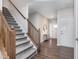 Inviting entryway featuring stylish wallpaper, wood floors, and a decorative mirror, complemented by a staircase at 1051 Macoun Dr, Westfield, IN 46074