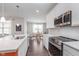 Well-lit kitchen with stainless steel appliances, white cabinets, and view of dining nook at 1051 Macoun Dr, Westfield, IN 46074