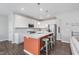 Bright kitchen with white cabinets, stainless appliances, and a large center island with seating at 1051 Macoun Dr, Westfield, IN 46074