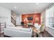 Inviting living room with a white couch and a decorative orange accent wall and entertainment center at 1051 Macoun Dr, Westfield, IN 46074