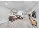 Spacious living room featuring plush carpeting, a comfortable brown sofa, and bright recessed lighting at 1051 Macoun Dr, Westfield, IN 46074