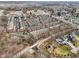 Aerial view of a community of brick townhomes with a creek running behind the property at 1072 3Rd Nw Ave, Carmel, IN 46032