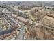 Aerial view of a community of brick townhomes next to a wooded area and stream at 1072 3Rd Nw Ave, Carmel, IN 46032