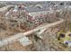 Aerial view of brick townhomes with bridge access and creek running behind the property at 1072 3Rd Nw Ave, Carmel, IN 46032