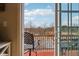 View of the tree-lined backyard from the balcony with chair at 1072 3Rd Nw Ave, Carmel, IN 46032