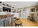 Finished basement with a custom bar, shelving, adjacent staircase and room access at 1072 3Rd Nw Ave, Carmel, IN 46032