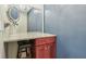 Bathroom vanity with a marble countertop, a dark red cabinet, and makeup mirrors at 1072 3Rd Nw Ave, Carmel, IN 46032
