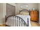 Charming bedroom with barn door, wood floors, and a metal bed frame at 1072 3Rd Nw Ave, Carmel, IN 46032