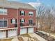 Brick townhouse with multi-car garages, private patios and black shutters at 1072 3Rd Nw Ave, Carmel, IN 46032