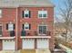Brick townhouse with multi-car garages, private patios and black shutters at 1072 3Rd Nw Ave, Carmel, IN 46032