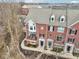 Exterior elevation of brick townhomes featuring private balcony and manicured front yards at 1072 3Rd Nw Ave, Carmel, IN 46032