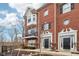 Elegant brick townhome showcasing architectural details and well-maintained grounds at 1072 3Rd Nw Ave, Carmel, IN 46032