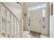 Bright foyer with tile flooring, stairs, and a white front door with sidelights at 1072 3Rd Nw Ave, Carmel, IN 46032