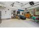 Finished garage game room featuring epoxy floors, lighting and dart board at 1072 3Rd Nw Ave, Carmel, IN 46032