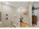 Bright landing area with wood floors, white railing, and a decorative table with artwork on the wall at 1072 3Rd Nw Ave, Carmel, IN 46032