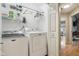 Functional laundry room with washer, dryer, shelving, and ample storage space, conveniently located near hallway at 1072 3Rd Nw Ave, Carmel, IN 46032