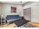 Cozy room features a gray futon, accent table and sliding closet doors at 1072 3Rd Nw Ave, Carmel, IN 46032
