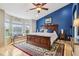 Spacious main bedroom featuring a large window nook, plush rug, wooden bed frame and accent wall at 1072 3Rd Nw Ave, Carmel, IN 46032