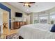 Bright and airy main bedroom with large windows, a dresser, and an adjoining doorway to the bathroom at 1072 3Rd Nw Ave, Carmel, IN 46032
