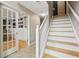 Staircase view with finished basement doors and adjacent room access at 1072 3Rd Nw Ave, Carmel, IN 46032