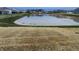 Scenic backyard featuring a tranquil pond, grassy area, and community surroundings at 11305 N Quillow Way, Monrovia, IN 46157