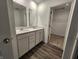 Bathroom featuring double sinks, white cabinets, quartz countertops, and a walk-in closet at 11305 N Quillow Way, Monrovia, IN 46157
