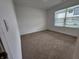 Bright bedroom with neutral carpet, large window, and ample natural light at 11305 N Quillow Way, Monrovia, IN 46157