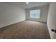 Cozy bedroom with neutral carpet, a bright window, and plenty of natural light at 11305 N Quillow Way, Monrovia, IN 46157