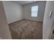 Bright bedroom with neutral carpet, large window, and ample natural light at 11305 N Quillow Way, Monrovia, IN 46157