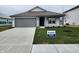 Charming single-story home with a gray garage door, fresh landscaping, and an inviting, covered entryway at 11305 N Quillow Way, Monrovia, IN 46157
