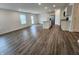 Spacious living room with hardwood floors and large windows, flowing into an open-concept kitchen with an island at 11305 N Quillow Way, Monrovia, IN 46157