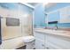Bright bathroom features a shower with sliding doors, a white vanity, and fresh blue walls at 12205 Whitebark Dr, Indianapolis, IN 46236
