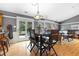 Cozy dining area features hardwood floors, gray walls, and a modern light fixture above the wooden dining table at 12205 Whitebark Dr, Indianapolis, IN 46236