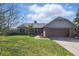 Charming ranch home featuring a brick facade, well-manicured lawn, and an attached two-car garage at 12205 Whitebark Dr, Indianapolis, IN 46236