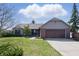 Charming ranch home featuring a brick facade, well-manicured lawn, and an attached two-car garage at 12205 Whitebark Dr, Indianapolis, IN 46236