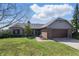 Inviting ranch home featuring a brick facade, well-manicured lawn, and an attached two-car garage at 12205 Whitebark Dr, Indianapolis, IN 46236