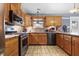 Updated kitchen with stainless steel appliances, custom backsplash, and light wood cabinetry at 12205 Whitebark Dr, Indianapolis, IN 46236