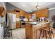 Traditional kitchen design with stainless steel appliances, light wood cabinetry, and patterned flooring at 12205 Whitebark Dr, Indianapolis, IN 46236