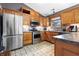 Well-lit kitchen with stainless steel appliances, light wood cabinetry, and custom tiled backsplash at 12205 Whitebark Dr, Indianapolis, IN 46236