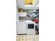 Laundry room with washer, dryer, storage shelves, and tiled floor at 12205 Whitebark Dr, Indianapolis, IN 46236