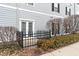 Apartment back door with small black gate at 12863 Tradd St # 1D, Carmel, IN 46032