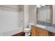 A full bathroom with granite counters and a shower over tub at 12863 Tradd St # 1D, Carmel, IN 46032