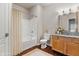 Bathroom featuring a shower-tub combo, granite vanity, and wood flooring at 12863 Tradd St # 1D, Carmel, IN 46032