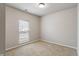 This bedroom features neutral walls, carpet, and a window at 12863 Tradd St # 1D, Carmel, IN 46032