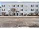 Multi-Gathering building with pale blue siding, black shutters and a bare tree in the yard at 12863 Tradd St # 1D, Carmel, IN 46032