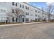 Multi-Gathering building with pale blue siding, black shutters and a bare tree in the yard at 12863 Tradd St # 1D, Carmel, IN 46032